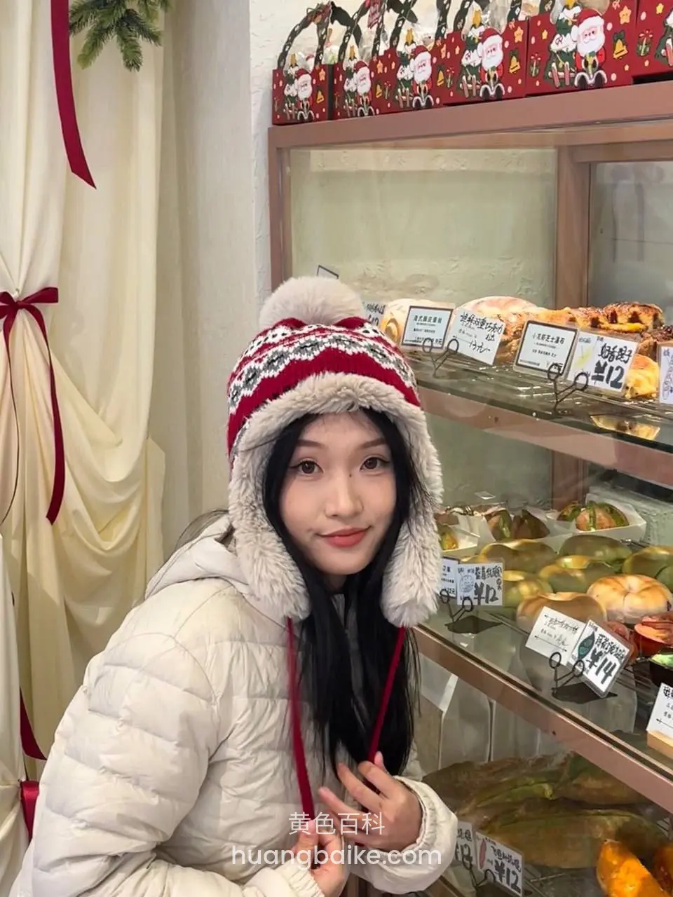 面包店柜台前回头看镜头，手抓着围巾绳