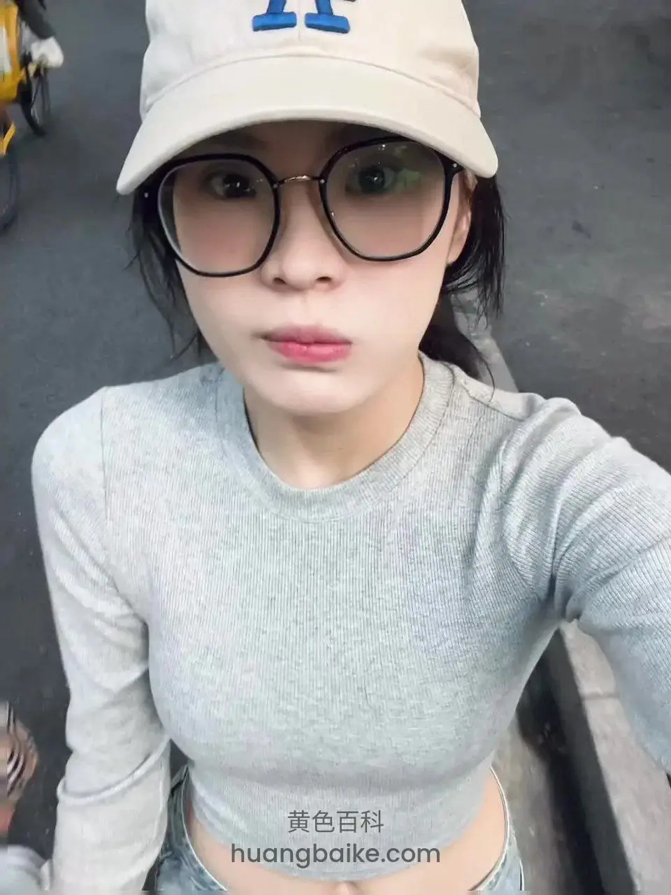 街边戴眼镜和帽子拿着手机