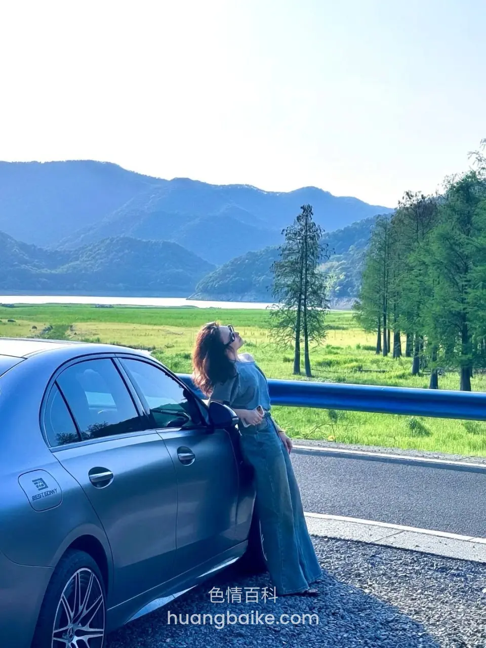 车旁站着望向远方湖山
