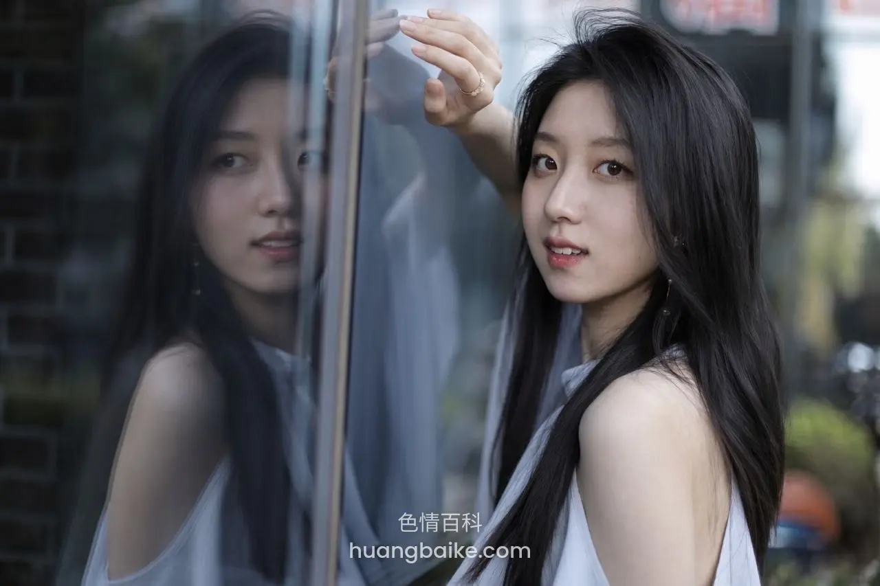 靠玻璃窗边回头看镜头，手扶着窗框