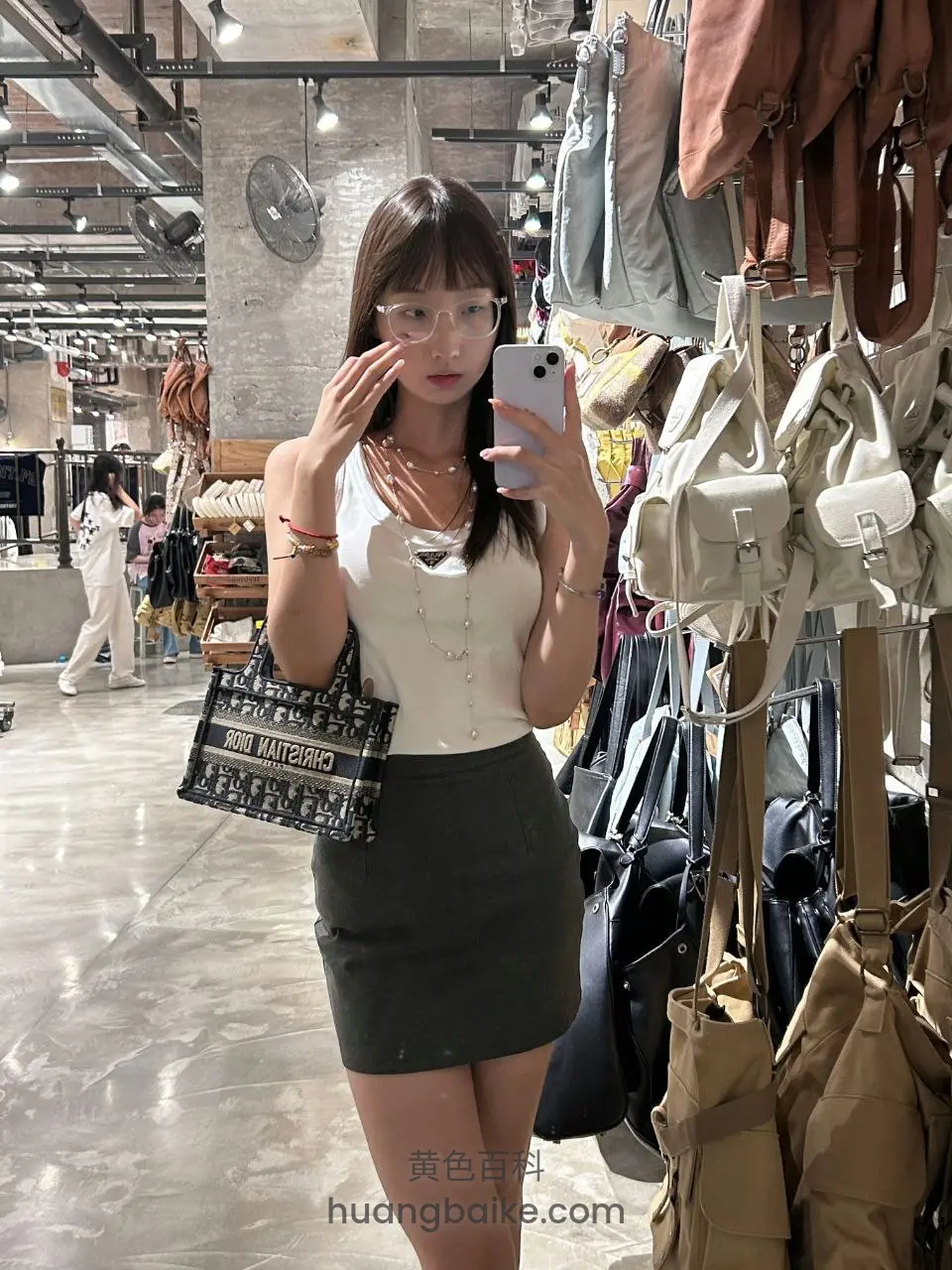 购物袋前举手机自拍调眼镜