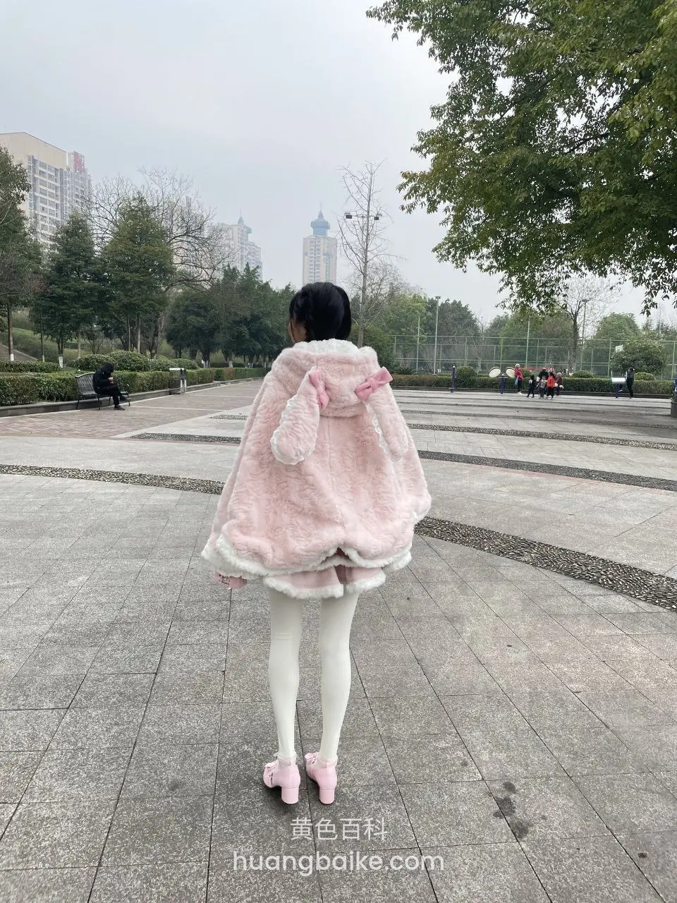公园石板路背影，身后树和建筑