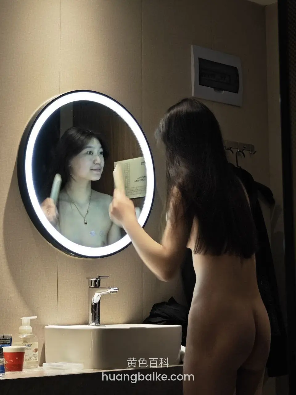 浴室镜子前拿着杯子自拍，镜子里映出脸