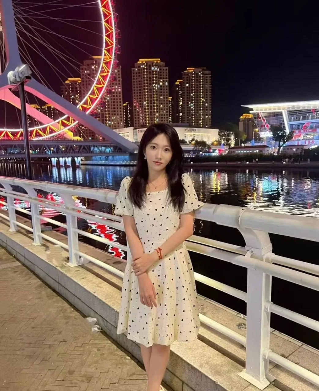 陈箐箐站在夜景摩天轮前