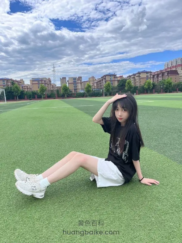 操场草坪上坐着，手搭额头看前方