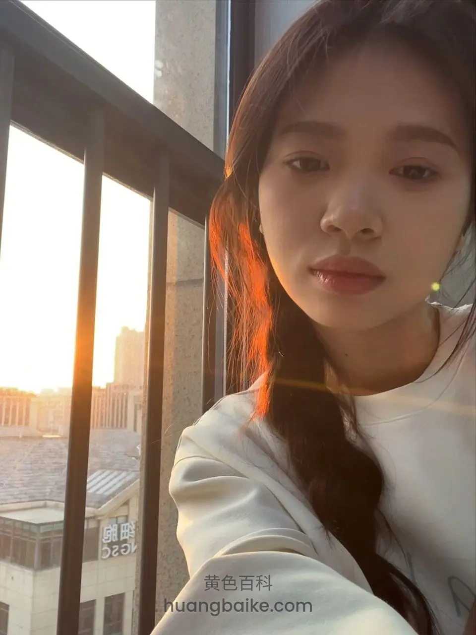 阳台对着夕阳，远处有楼房