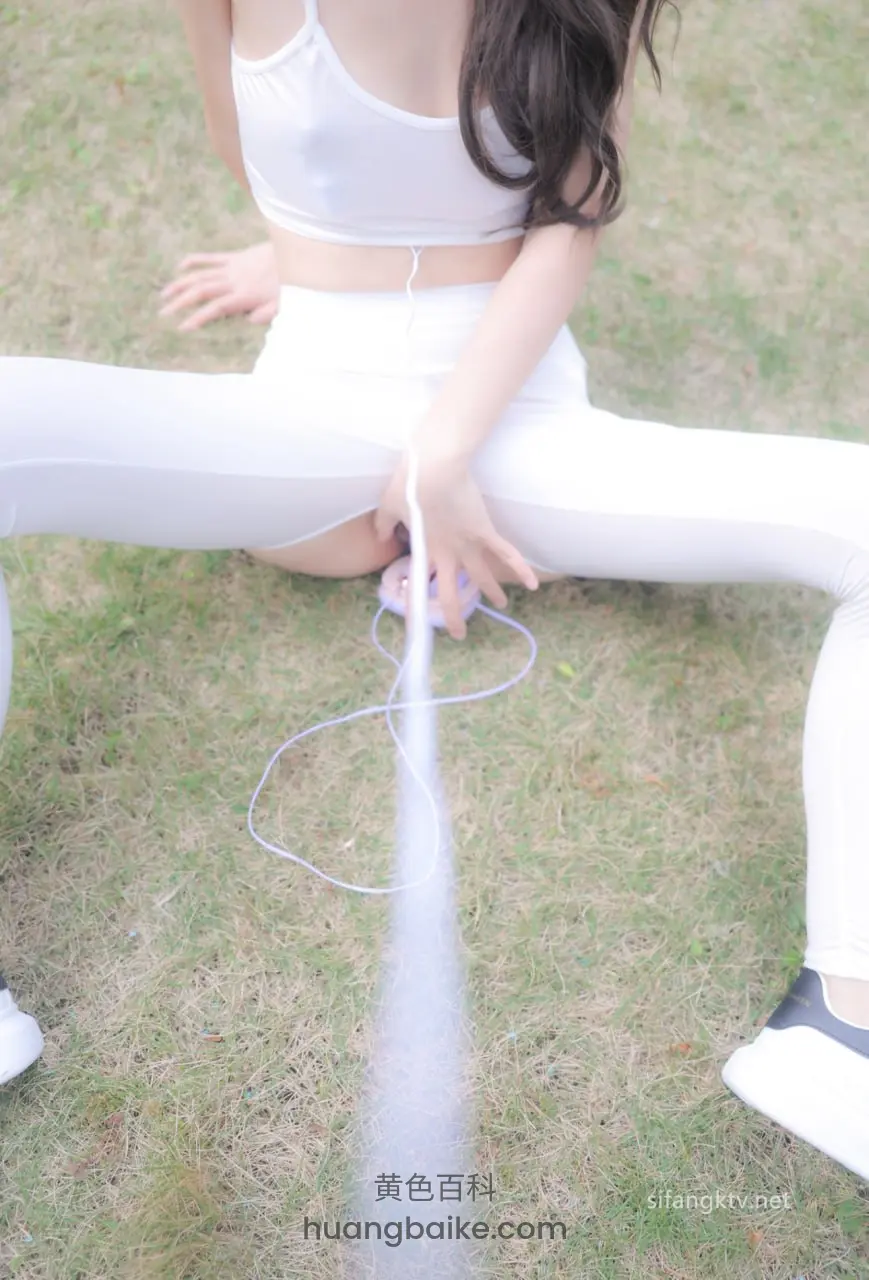 草地上分腿坐着拉耳机线 镜头对着手
