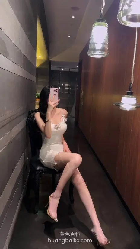 酒店走廊黑椅上坐着举手机自拍