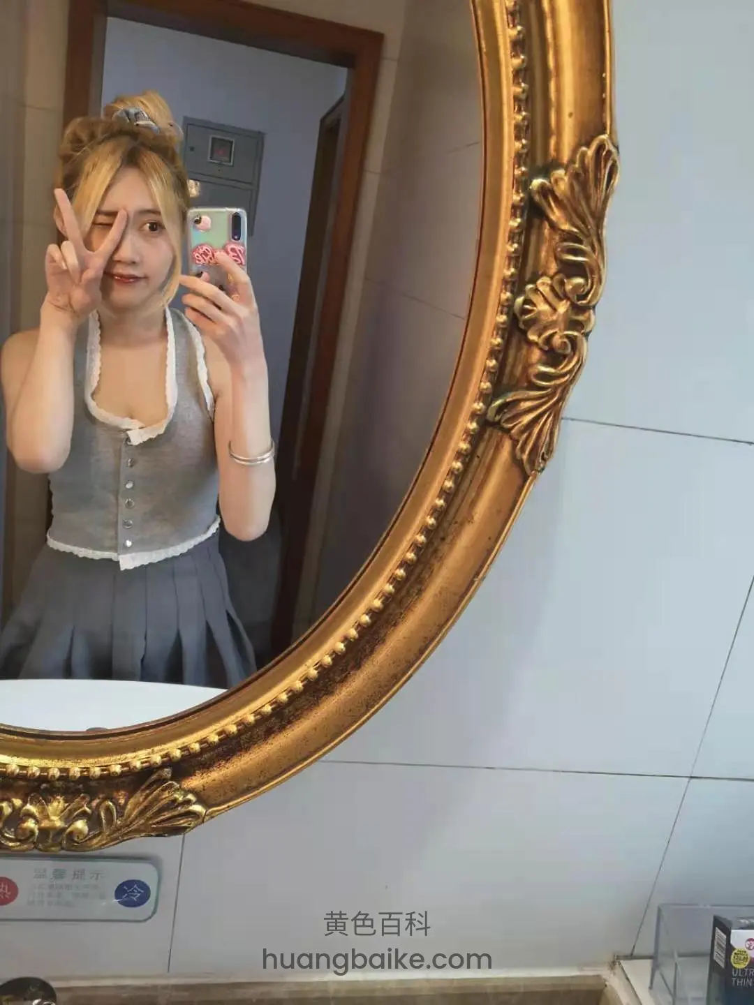 镜子前举手机自拍，身后门和墙