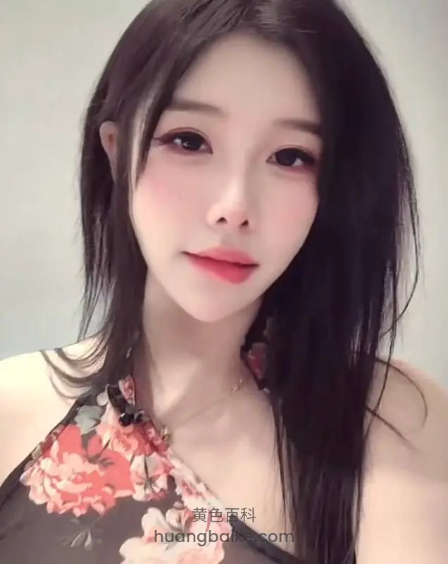对着镜头微笑，穿着花朵图案吊带上衣